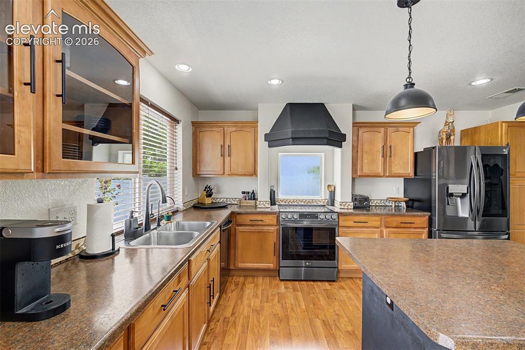 Image 13 of 43: Generous counter space wraps the perimeter of this functional kitchen, with