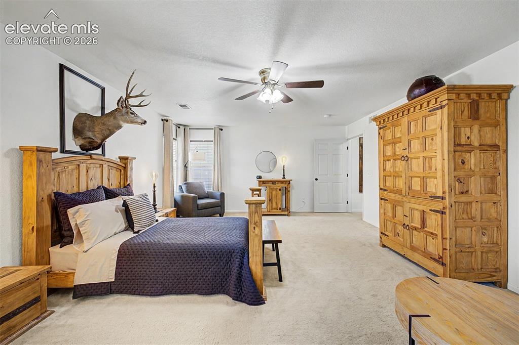 Image 22 of 43: Multiple windows on two walls fill this primary suite with natural light th