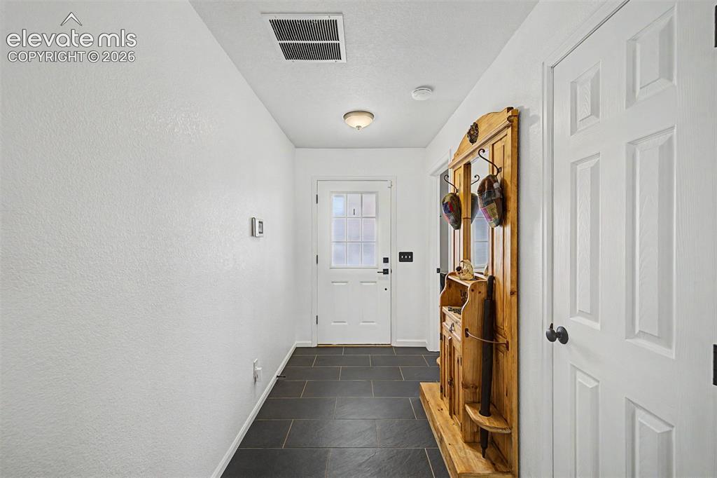 Image 3 of 43: New slate tile flooring sets the tone the moment you enter, providing both