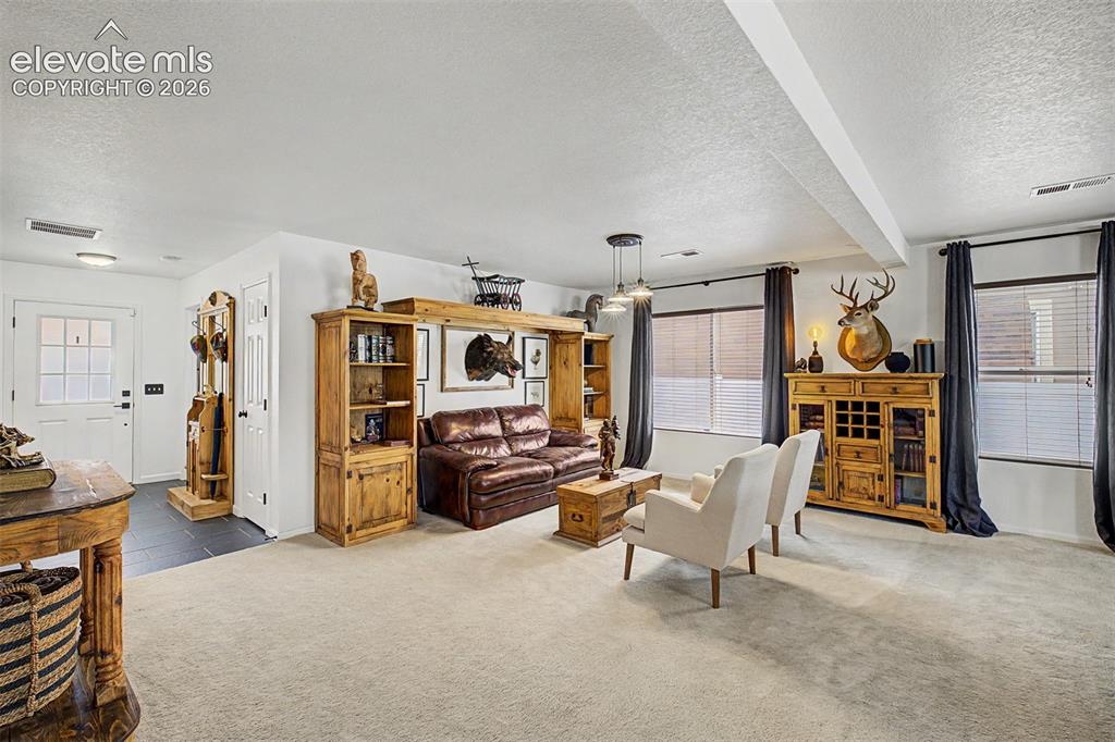 Image 5 of 43: Generously sized, this front living space is, with room for multiple seatin