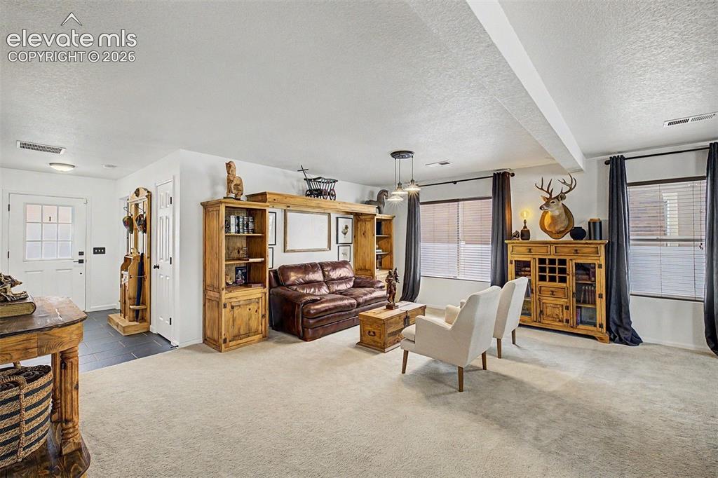 Image 5 of 43: Generously sized, this front living space is, with room for multiple seatin