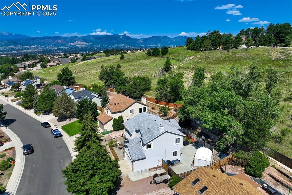 Image 3 of 50: Aerial view of residential area with a mountainous background