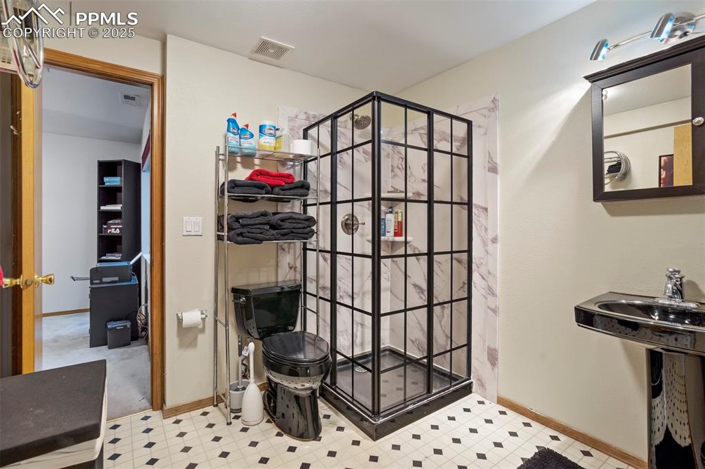 Image 42 of 50: Bathroom featuring a stall shower and tile patterned floors