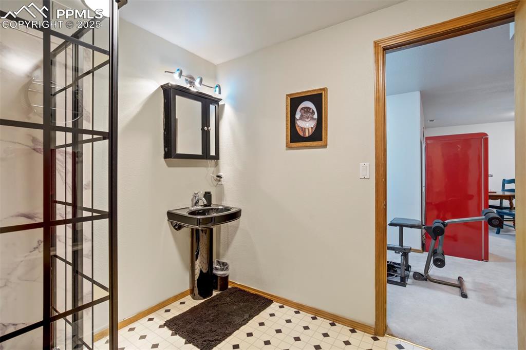 Image 43 of 50: Bathroom featuring baseboards and tile patterned floors