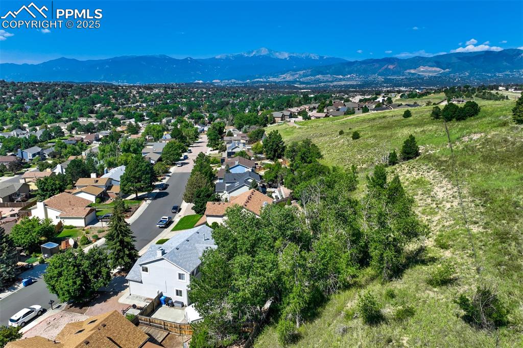 Image 47 of 50: Aerial perspective of suburban area featuring a mountain backdrop