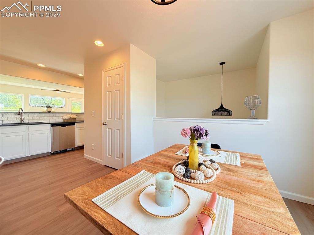 Image 15 of 44: Dining area featuring light wood-style flooring and recessed lighting