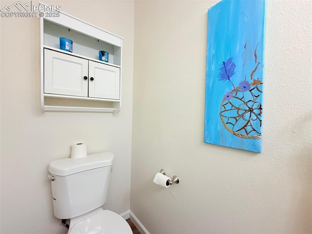 Image 21 of 44: Half bath with toilet and baseboards