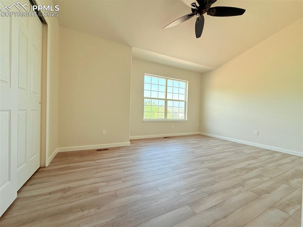 Image 25 of 44: Unfurnished bedroom featuring light wood-type flooring, a closet, lofted ce