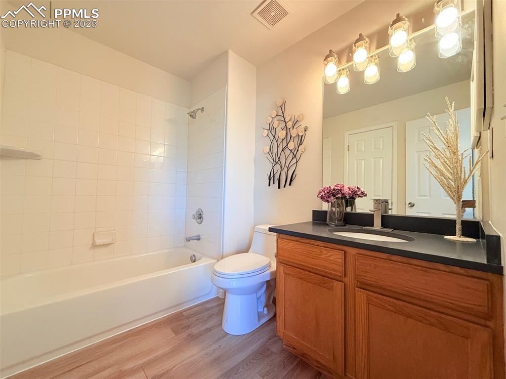 Image 29 of 44: Bathroom featuring vanity, bathing tub / shower combination, and light wood