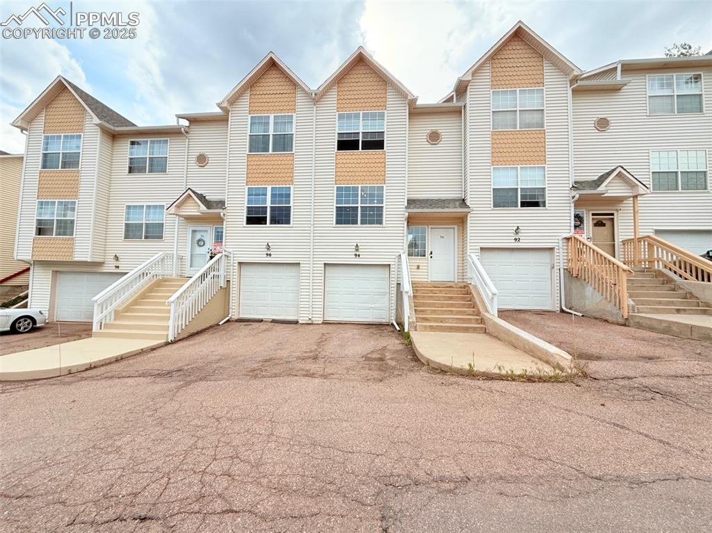Image 3 of 44: View of front facade featuring asphalt driveway and a garage