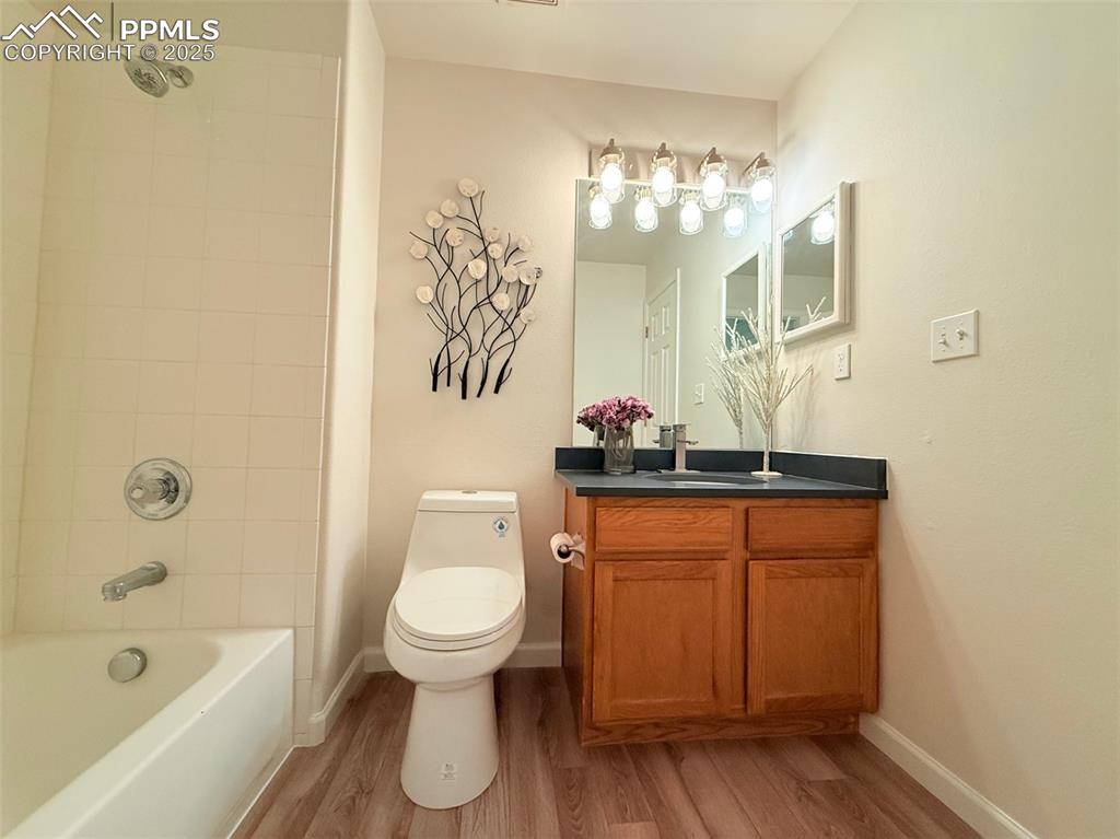 Image 31 of 44: Full bathroom with vanity, shower / washtub combination, and light wood fin