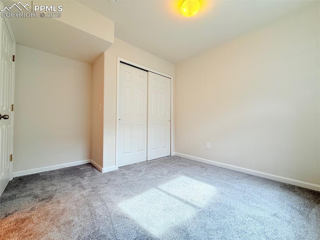 Image 34 of 44: Unfurnished bedroom featuring a closet and carpet flooring