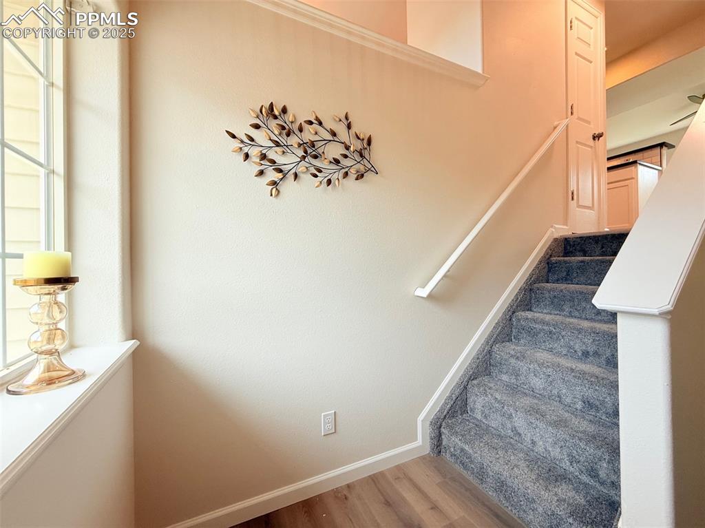 Image 4 of 44: Staircase with baseboards and wood finished floors
