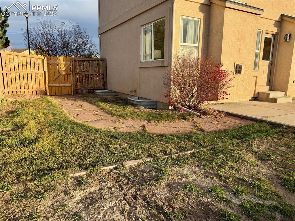 Image 35 of 38: View of yard featuring a gate and a patio area