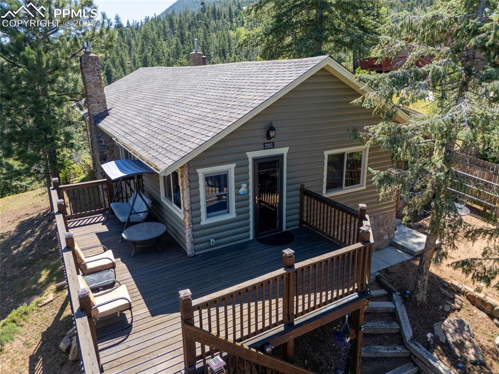Caption: Wooden deck featuring a forest view
