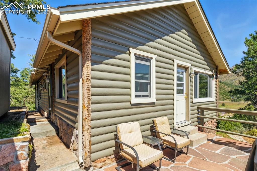 Image 10 of 43: View of property exterior with log veneer siding