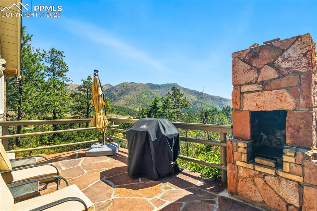 Image 11 of 43: View of patio with a mountain view and area for grilling