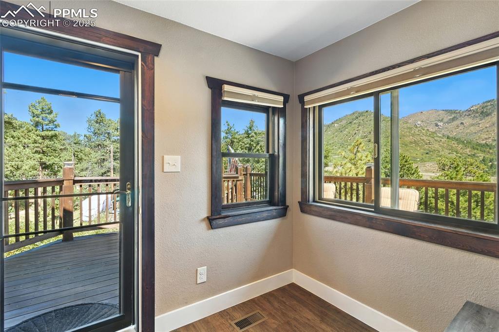 Image 13 of 43: Entryway featuring a textured wall, wood finished floors, and a mountain vi