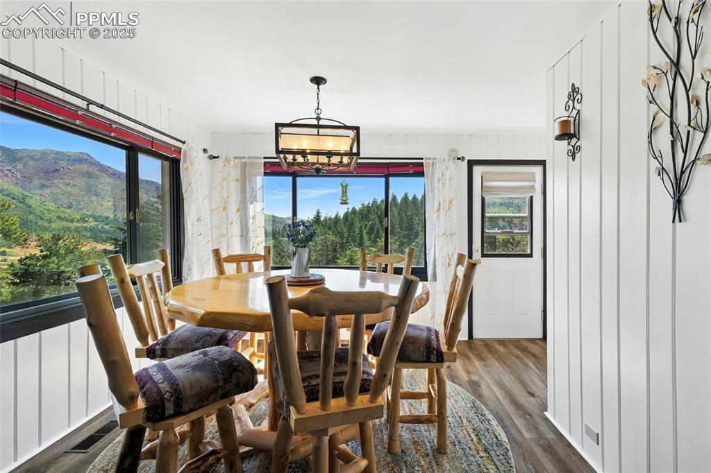 Image 22 of 43: Dining space with healthy amount of natural light, dark wood-type flooring,