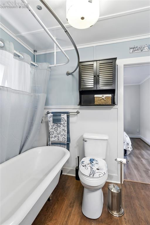 Image 27 of 43: Bathroom featuring dark wood-style floors, a shower with shower curtain, an