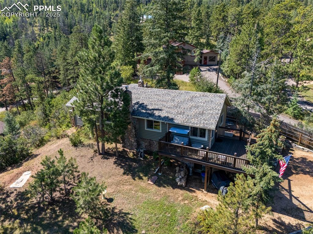 Image 3 of 43: Aerial view of property and surrounding area featuring a heavily wooded are