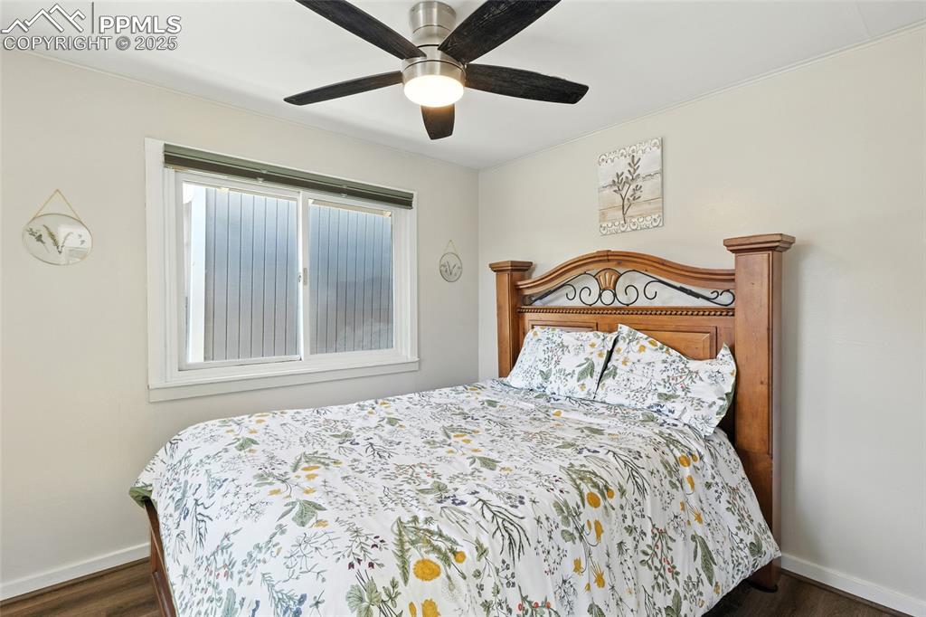 Image 31 of 43: Bedroom featuring a ceiling fan and dark wood-style floors