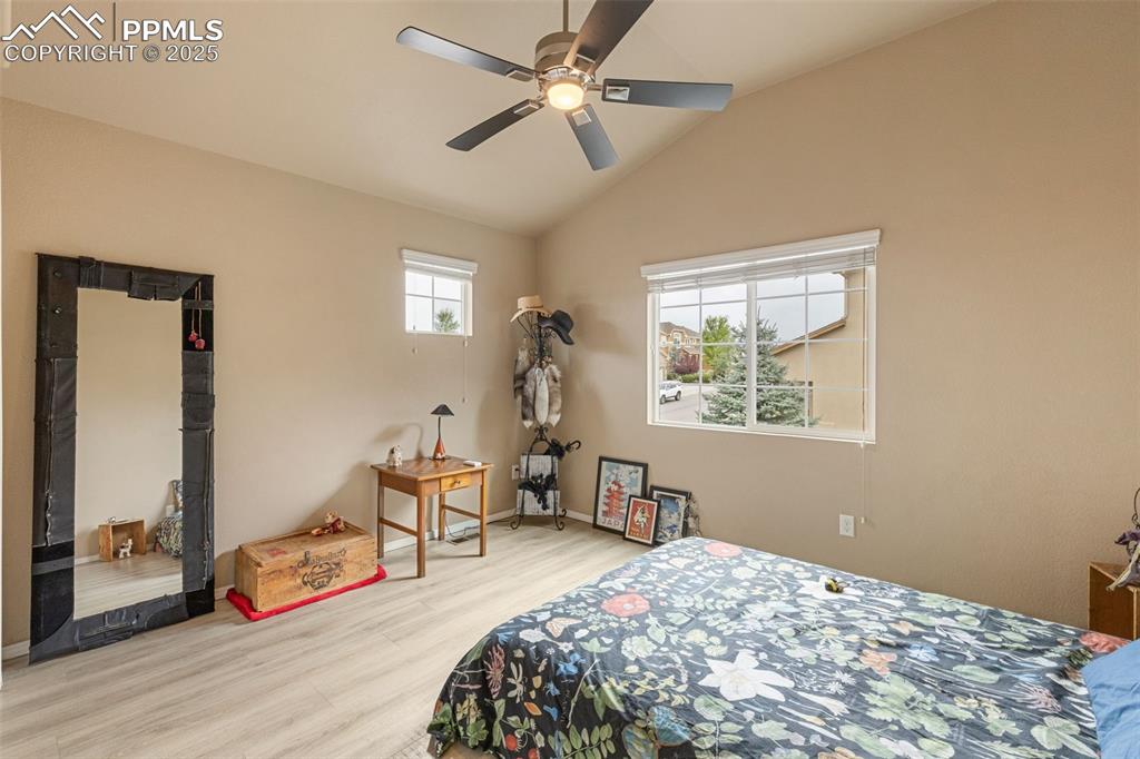 Image 29 of 50: Bedroom featuring vaulted ceiling, light wood-style flooring, and a ceiling