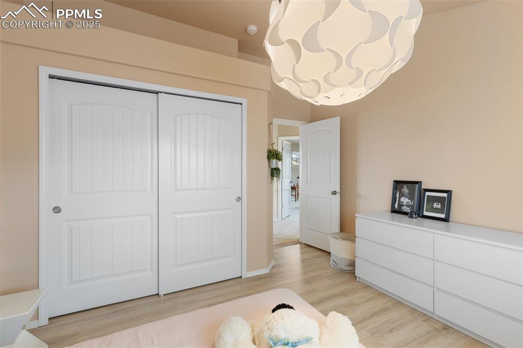 Image 33 of 50: Bedroom with light wood-style flooring and a closet