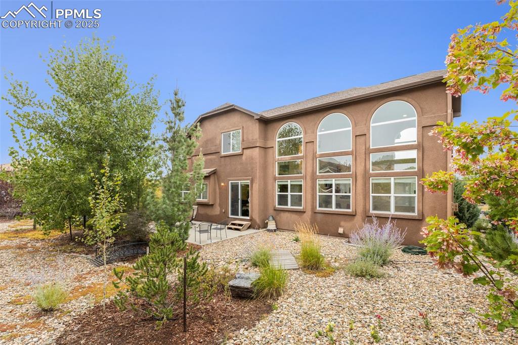 Image 39 of 50: Back of property featuring a patio area and stucco siding