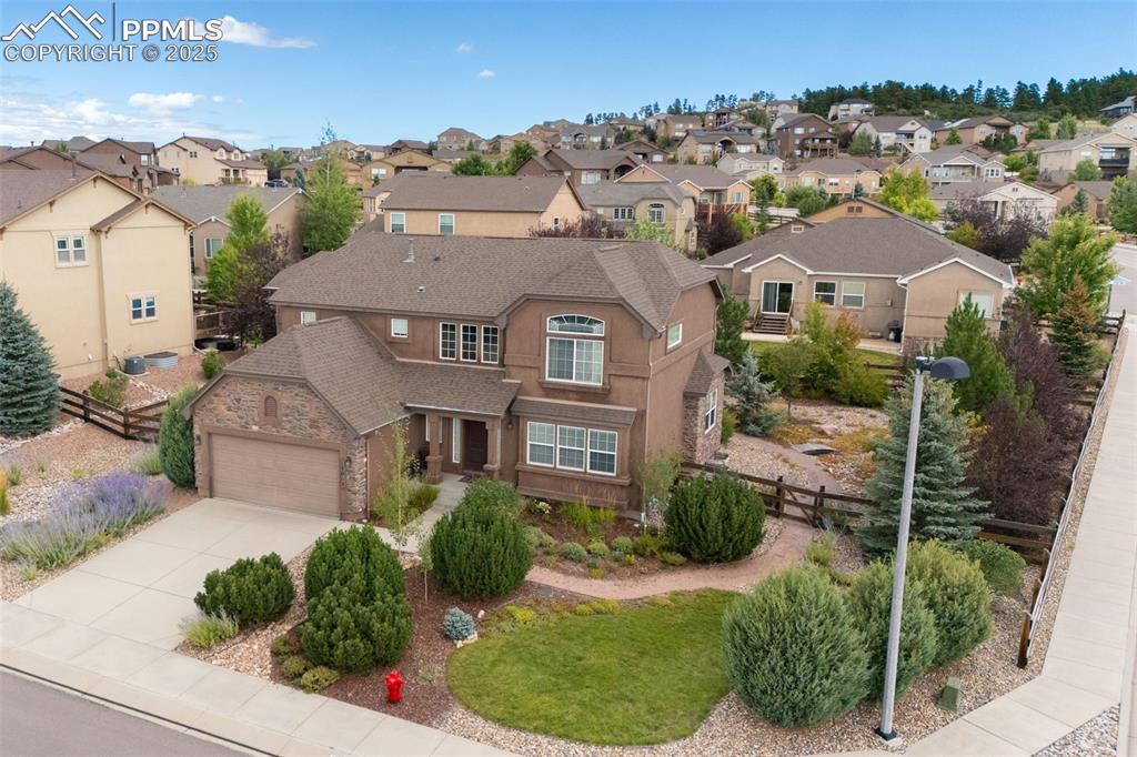 Image 42 of 50: Traditional-style house with a residential view, a shingled roof, stucco si