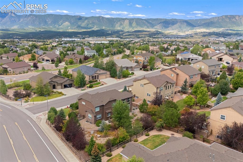 Image 45 of 50: Aerial view of residential area with a mountainous background