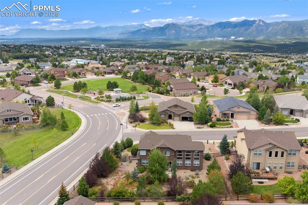 Image 46 of 50: Aerial perspective of suburban area with a mountainous background