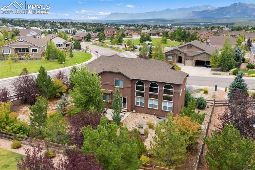 Image 47 of 50: Aerial view of residential area with a mountainous background