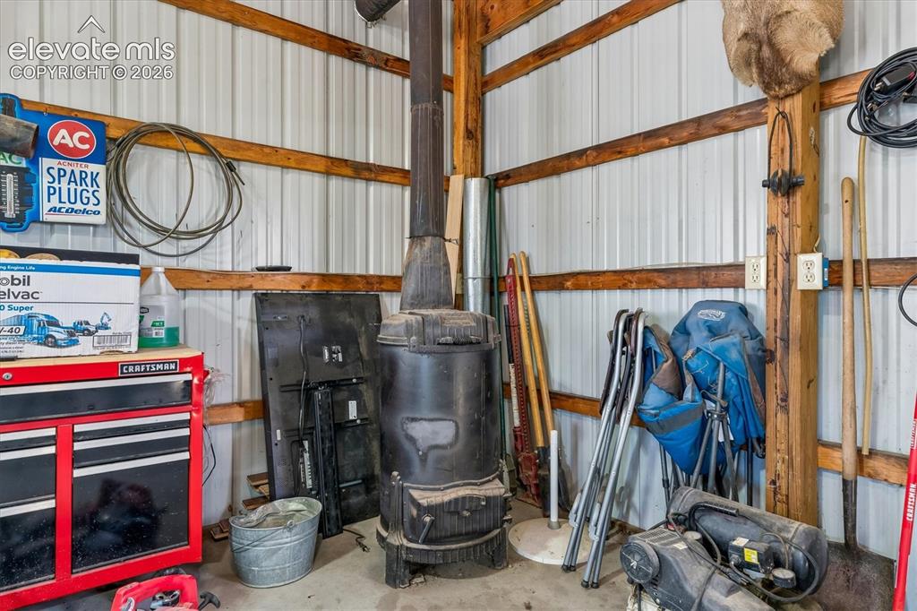 Image 25 of 34: Shop with wood burning stove