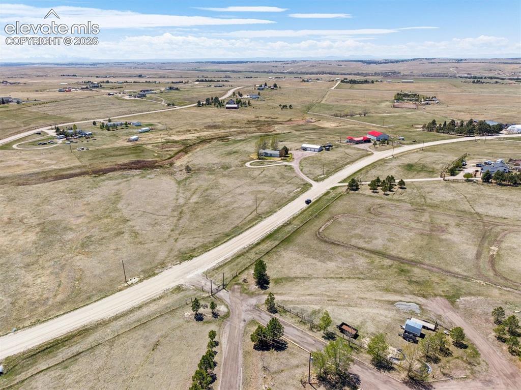 Image 27 of 34: Expansive rural landscape featuring a network of unpaved roads and scattere