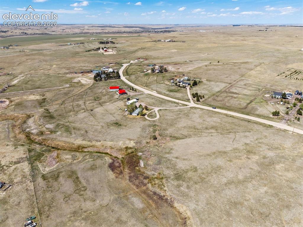 Image 28 of 34: Expansive rural landscape featuring scattered residences and extensive open
