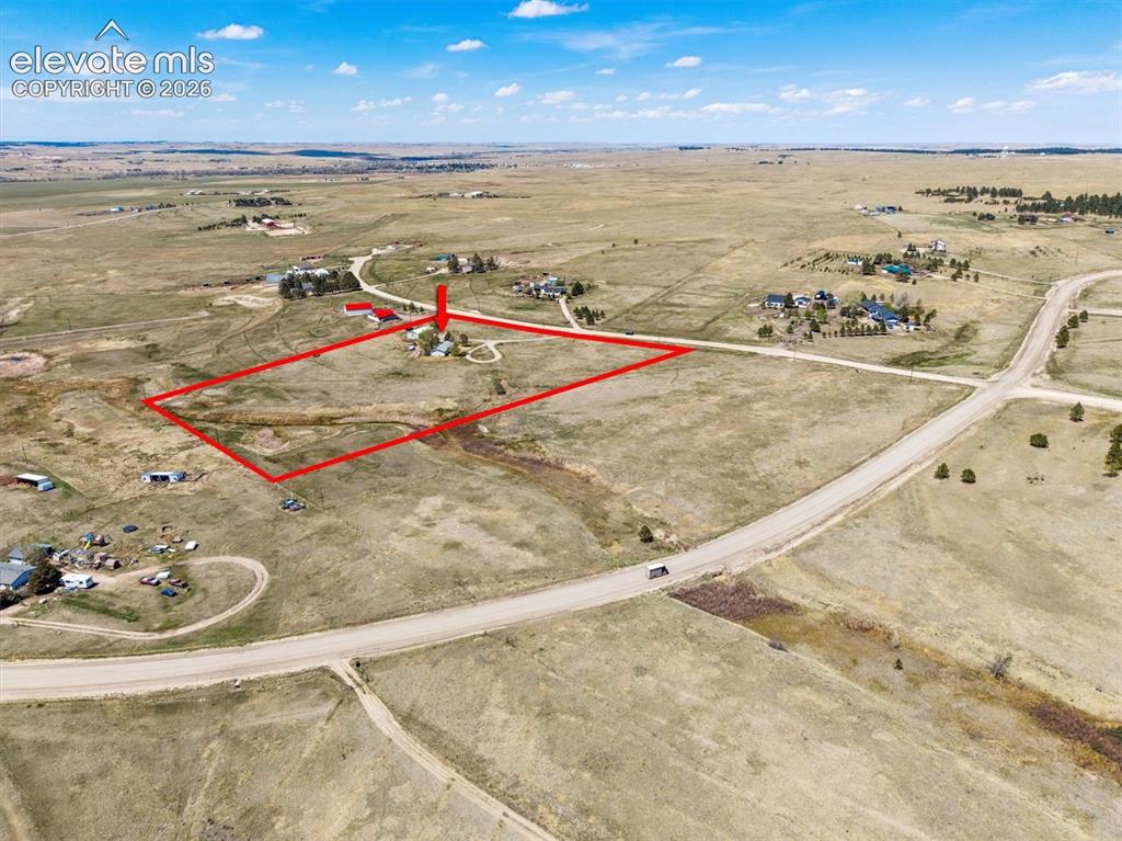 Image 35 of 40: Expansive rural property featuring a primary residence, outbuildings, and a