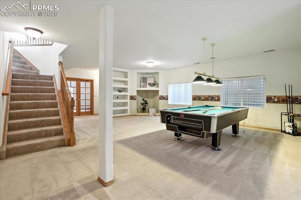 Image 24 of 50: Recreation room with billiards, carpet, and french doors