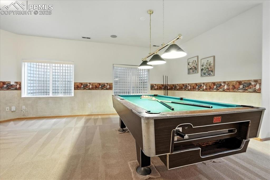 Image 25 of 50: Recreation room with billiards table and carpet floors