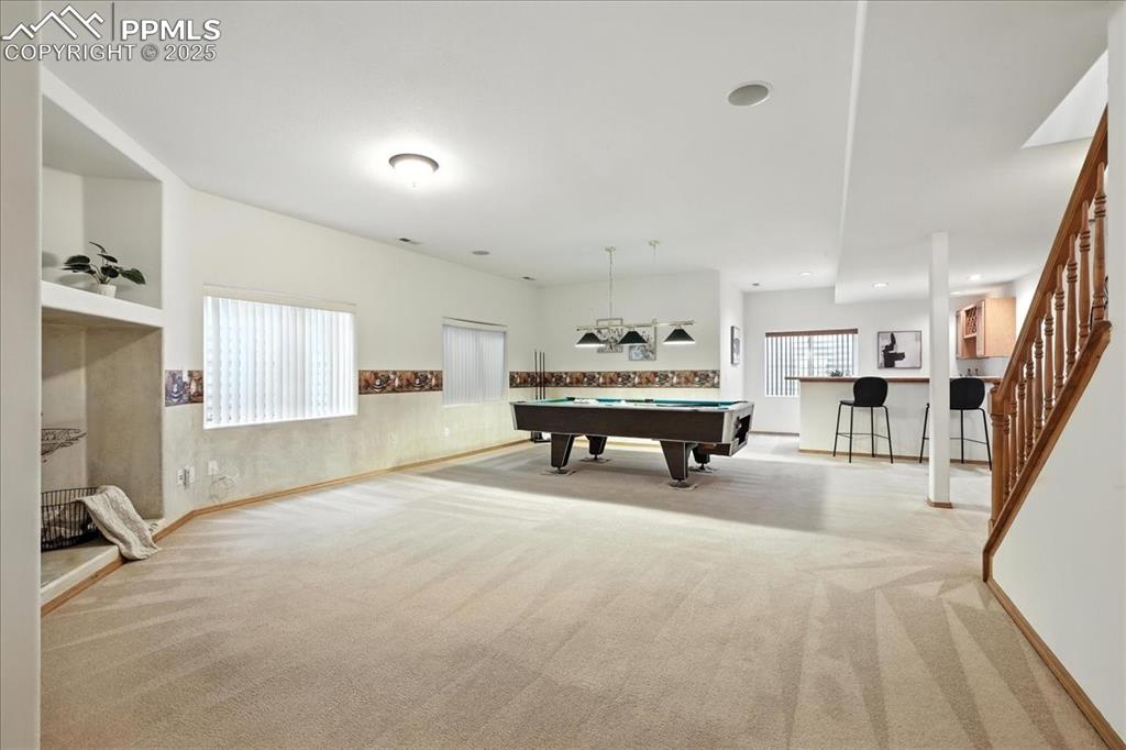 Image 28 of 50: Recreation room with pool table and carpet flooring