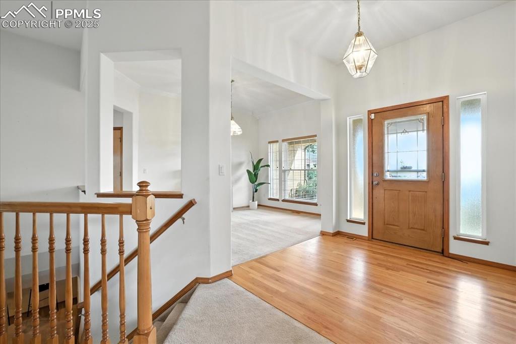 Image 3 of 50: Entryway featuring wood finished floors and carpet floors