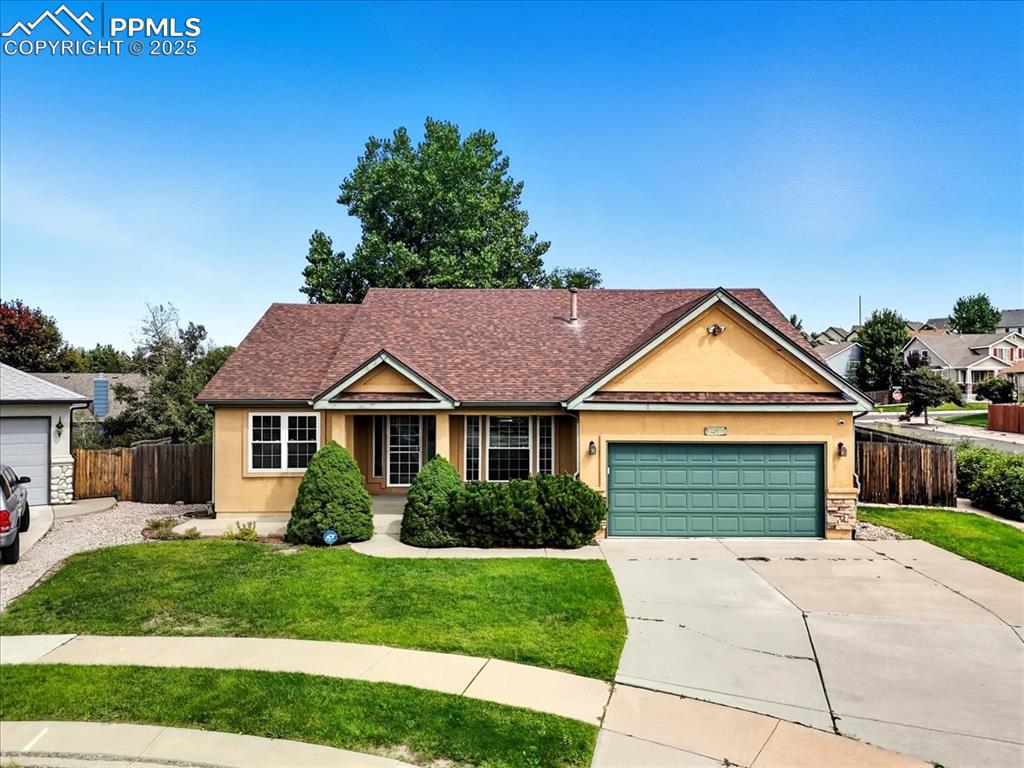 Image 50 of 50: Ranch-style house with stucco siding, a shingled roof, concrete driveway, a