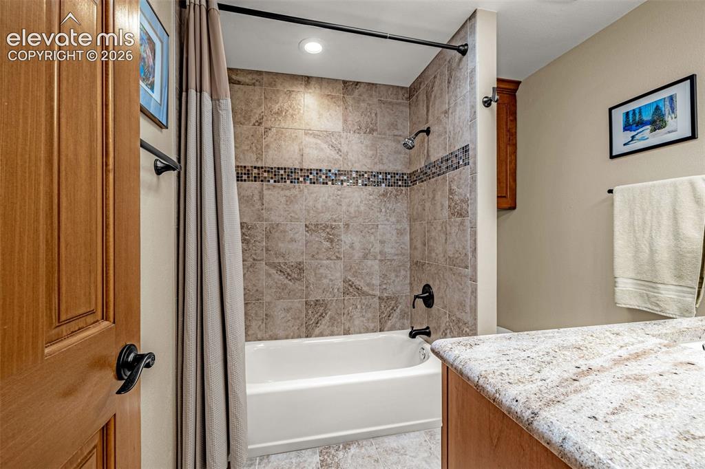 Image 17 of 42: Full bathroom with tile surround