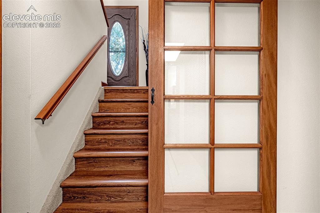 Image 19 of 42: Stairway includes custom overlay non-slip tread plus barn door to provide p