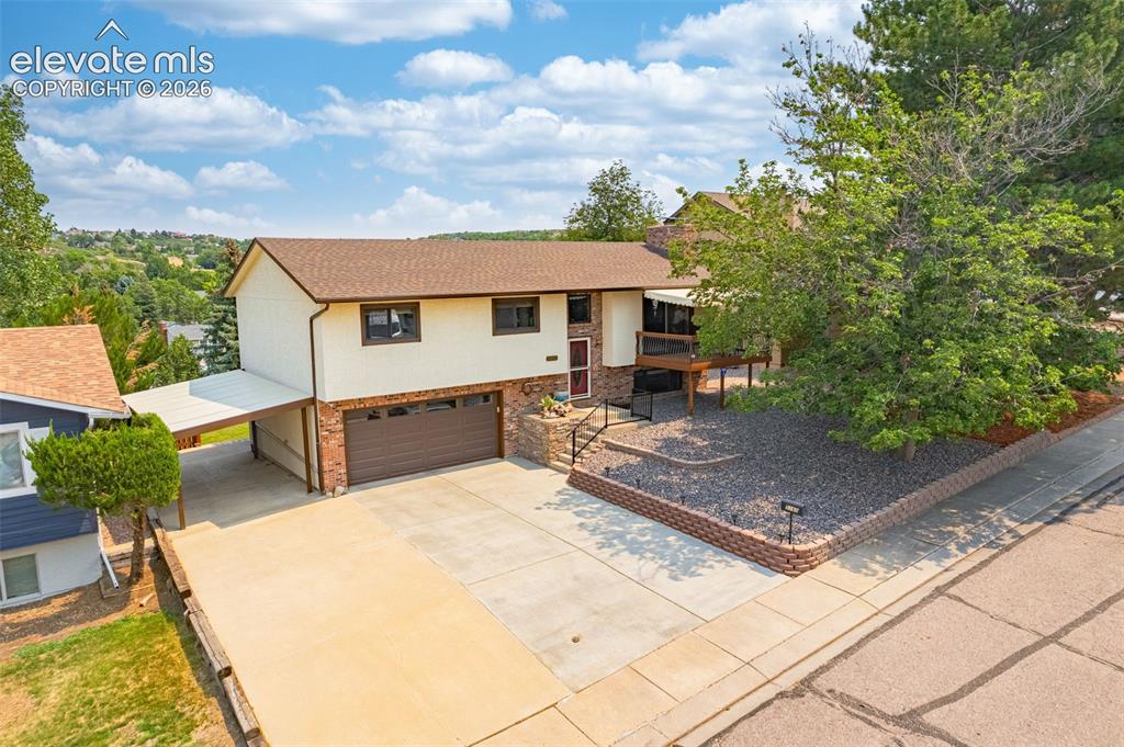 Image 2 of 42: Move in ready with a wonderful front covered deck with views of Pikes Peak