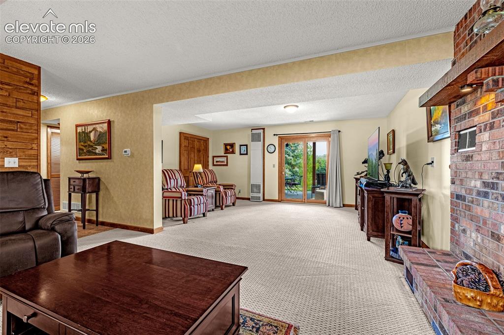 Image 22 of 42: Family room has walk-out to lower patio and backyard