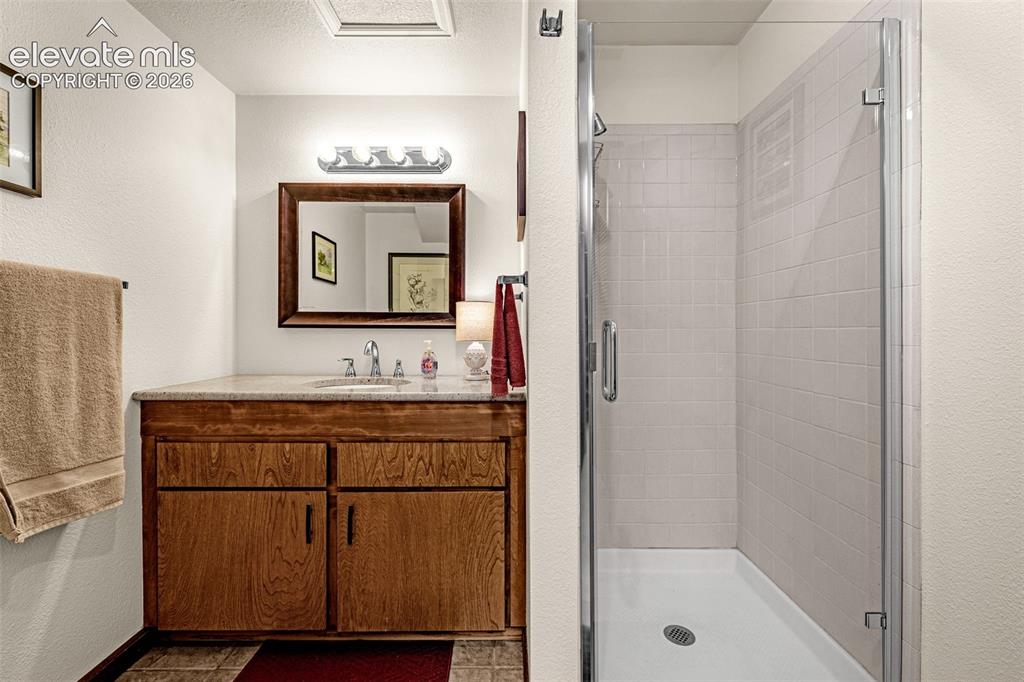 Image 23 of 42: 3/4 bath downstairs with walk-in shower