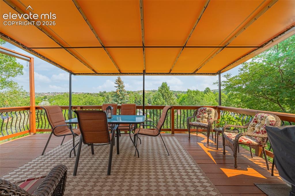 Image 25 of 42: Back deck with commercial grade awning perfect for summer BBQs!