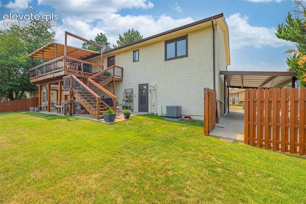 Image 29 of 42: Back of house with access to carport plus access to oversized finished insu