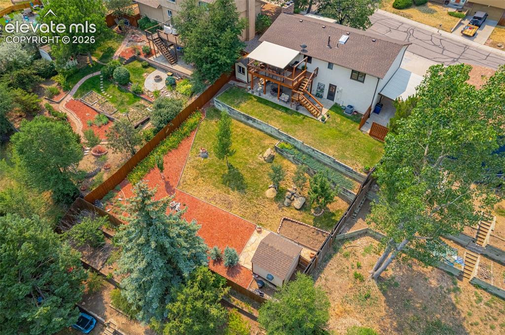 Image 7 of 42: Huge landscaped, fenced backyard with covered back patio plus lower patio!